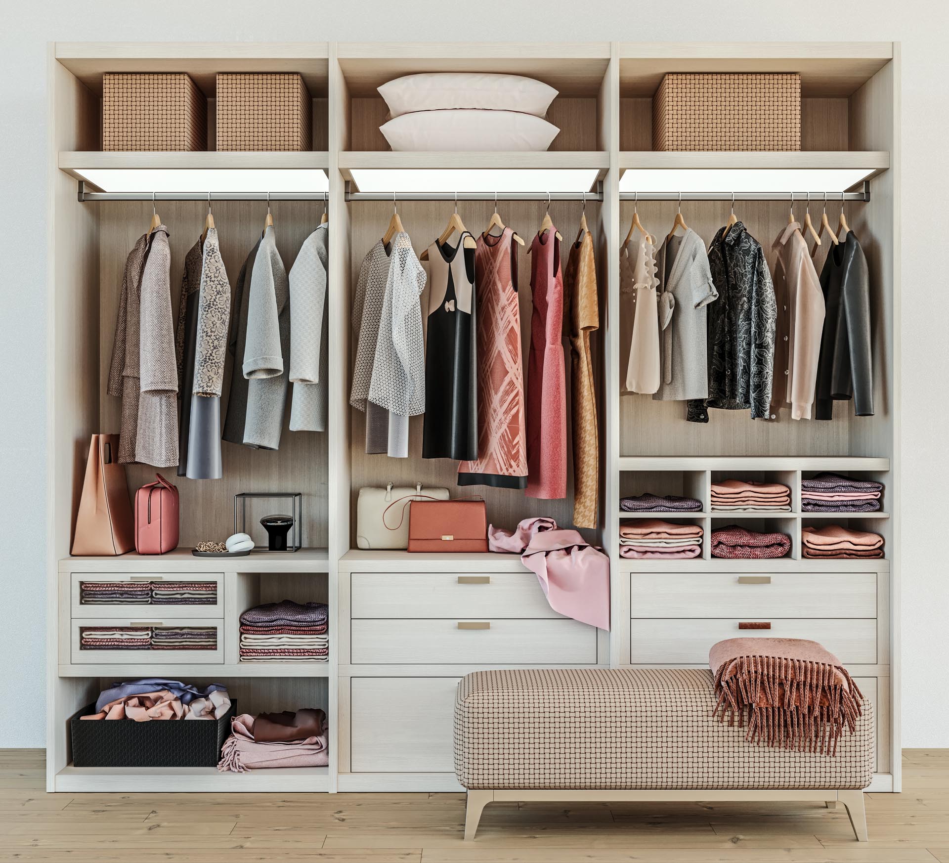 modern wooden wardrobe with clothes hanging on rail in walk in closet by Hammond Kitchens and Bath